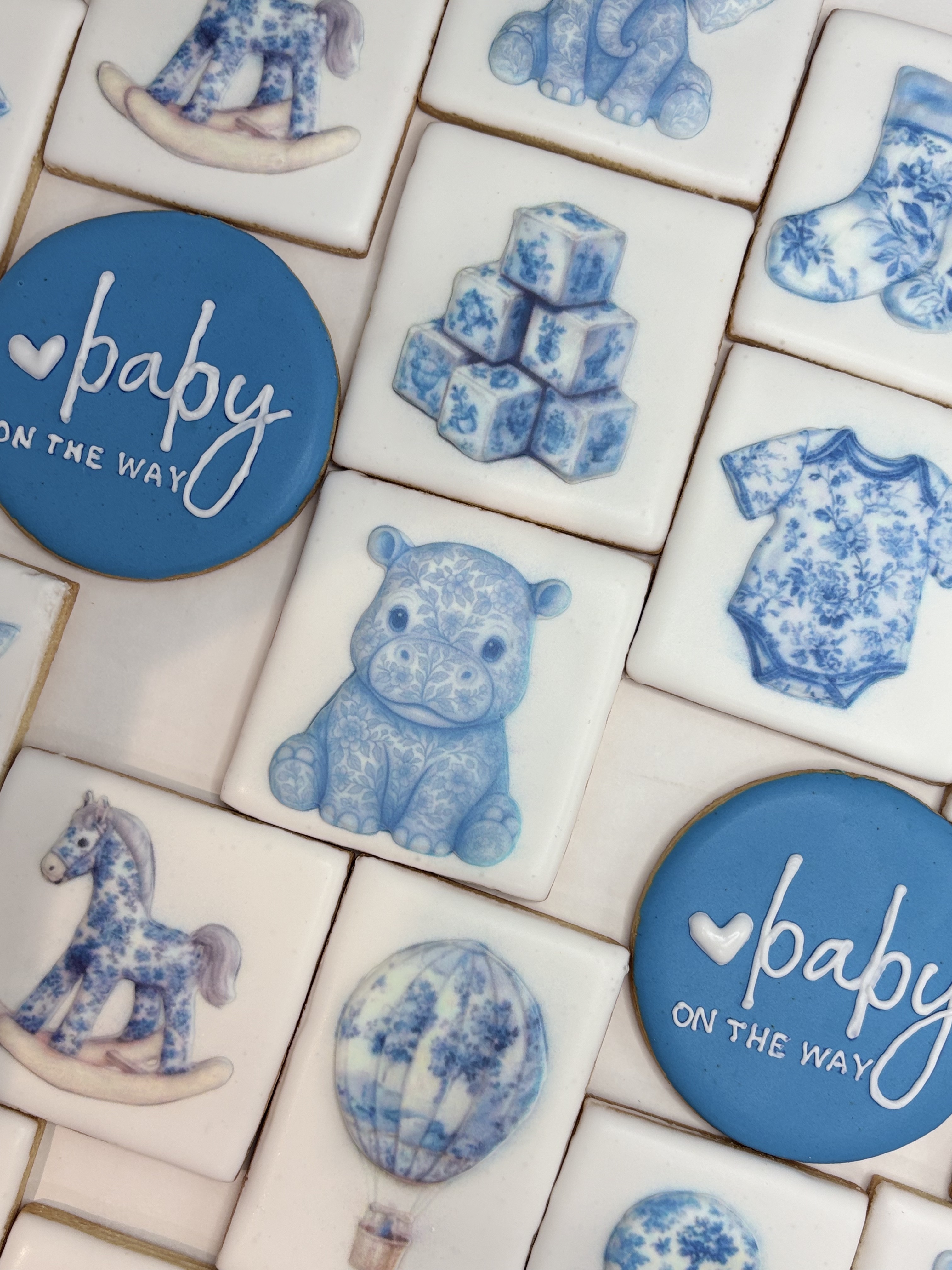 Baby blue themed printed cookies for a baby shower
